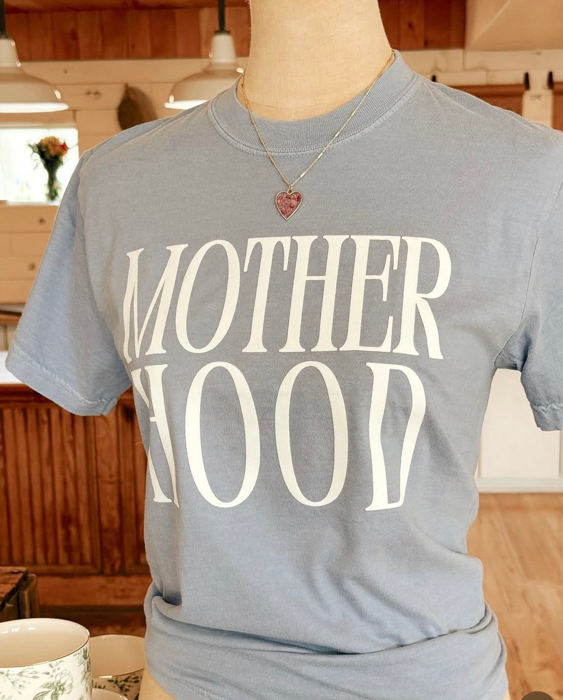 Motherhood graphic t-shirt in light denim blue with minimalist design, soft unisex tee for women and moms